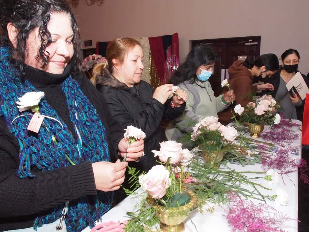 A group of women working in a floral design workshop.